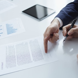 Two businessmen while signing a contract