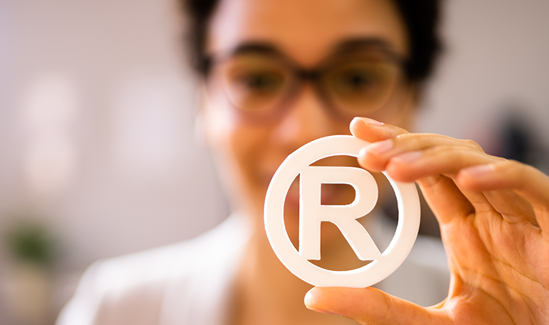 Woman holding the registered trademark symbol<br />
